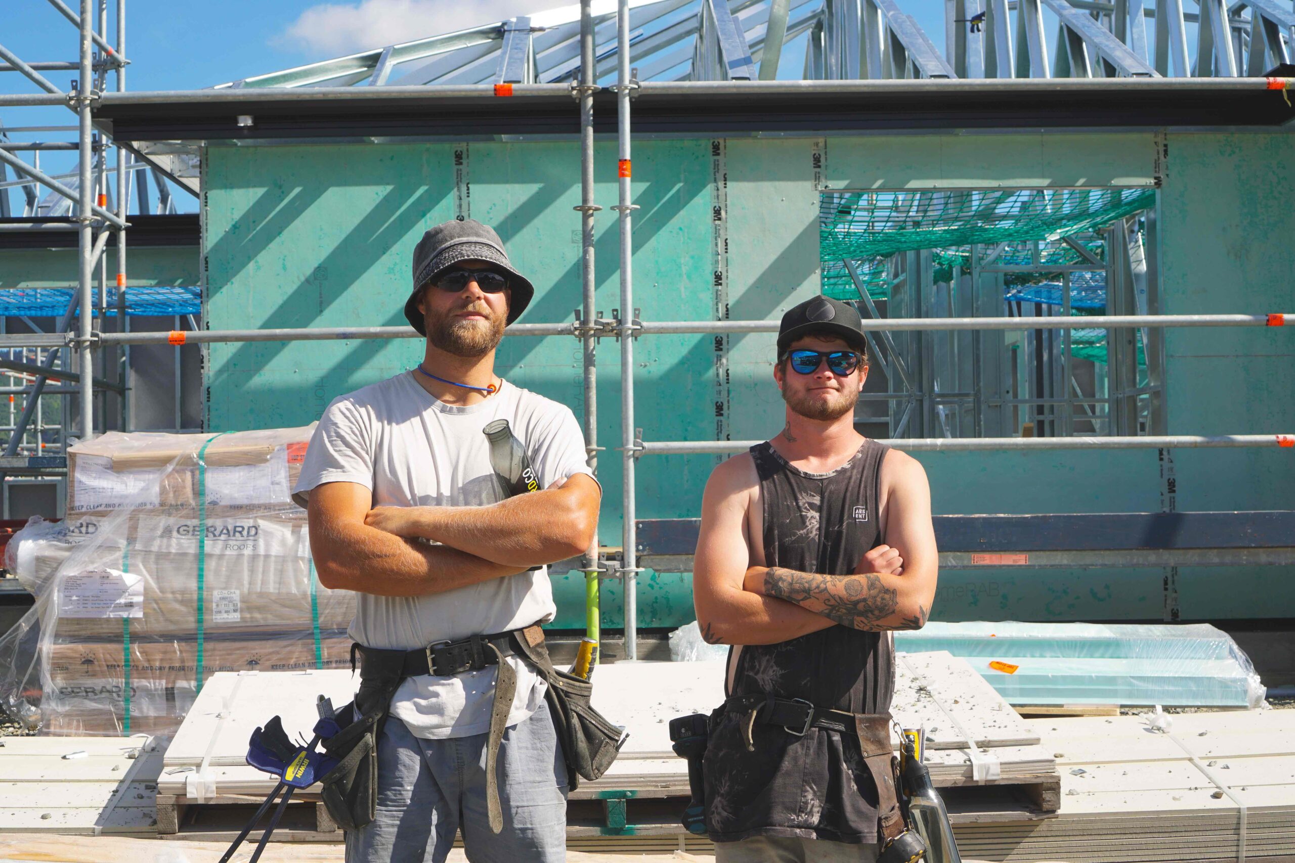Construction workers with attitude, arms folded looking at camera