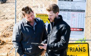 Two workers looking at Ipad