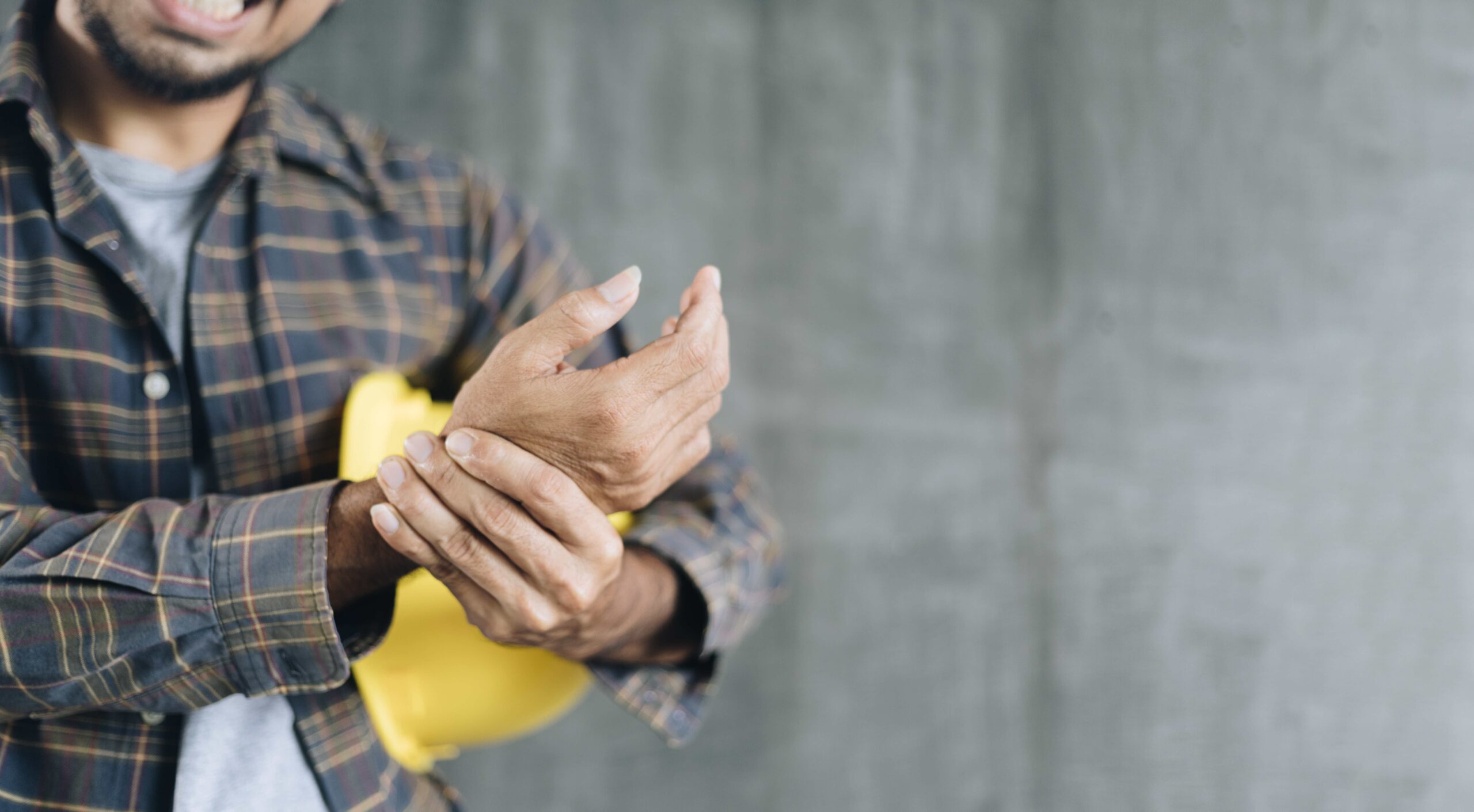 worker holding injured hand